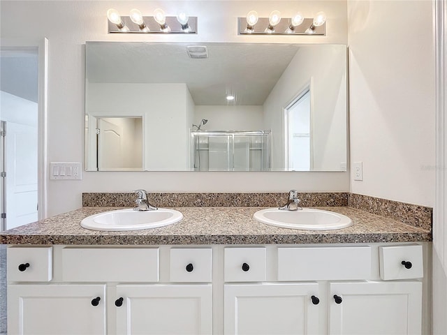 bathroom featuring vanity and an enclosed shower