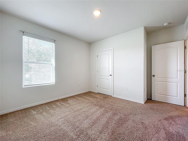 unfurnished bedroom featuring carpet floors and a textured ceiling