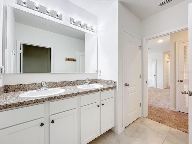 bathroom featuring tile patterned flooring and vanity