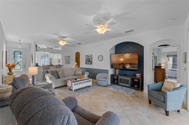 tiled living room featuring ceiling fan