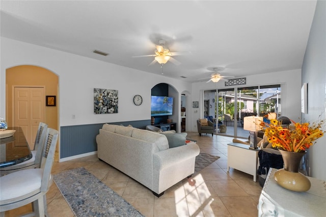 tiled living room with ceiling fan