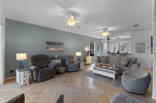 tiled living room with ceiling fan