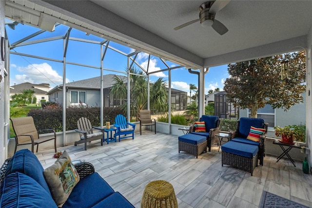 view of patio with a lanai, ceiling fan, and an outdoor living space