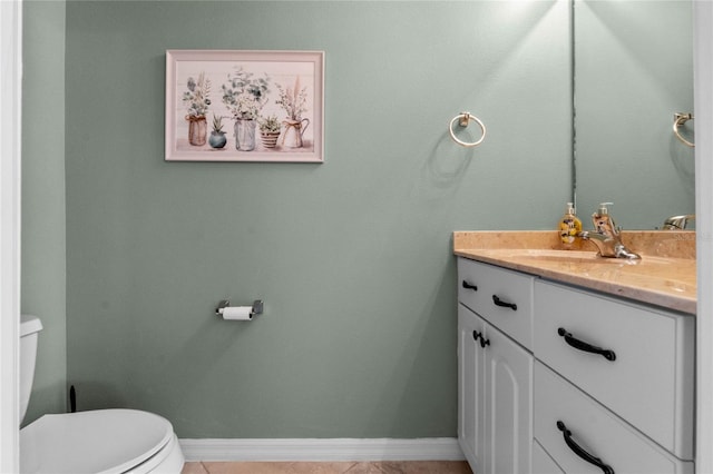 bathroom featuring tile patterned flooring, vanity, and toilet