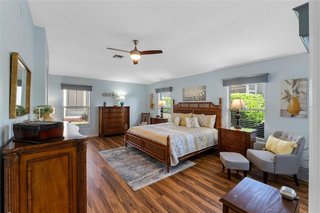 bedroom with ceiling fan and dark hardwood / wood-style flooring