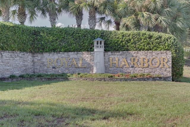 community / neighborhood sign with a yard