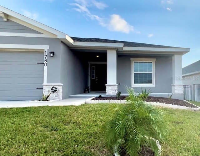 entrance to property with a lawn and a garage