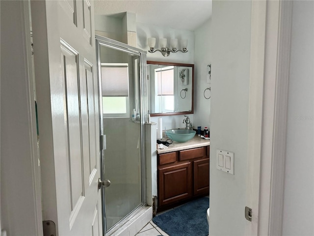 bathroom featuring tile patterned flooring, vanity, and a shower with door