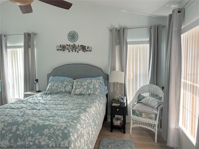 bedroom with hardwood / wood-style floors, ceiling fan, and lofted ceiling