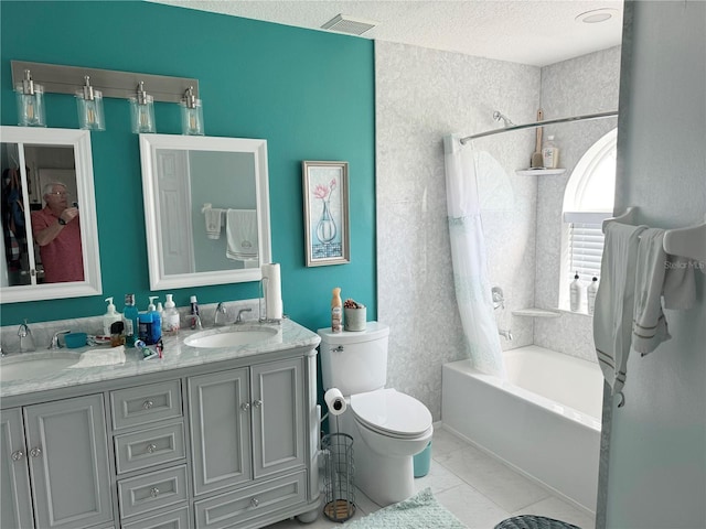 full bathroom featuring tile patterned floors, shower / bathtub combination, vanity, a textured ceiling, and toilet