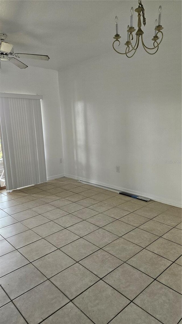 652 Chelsea Dr, Davenport, FL 33897 - unfurnished room featuring ceiling fan, a chandelier, light tile patterned flooring, and baseboards