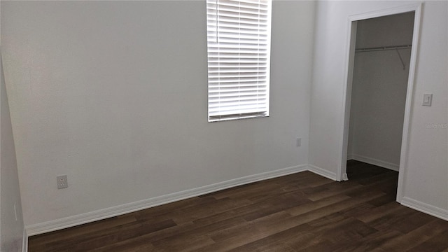 unfurnished bedroom featuring dark hardwood / wood-style floors and a closet