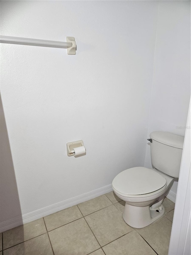 652 Chelsea Dr, Davenport, FL 33897 - bathroom featuring toilet, tile patterned floors, and baseboards