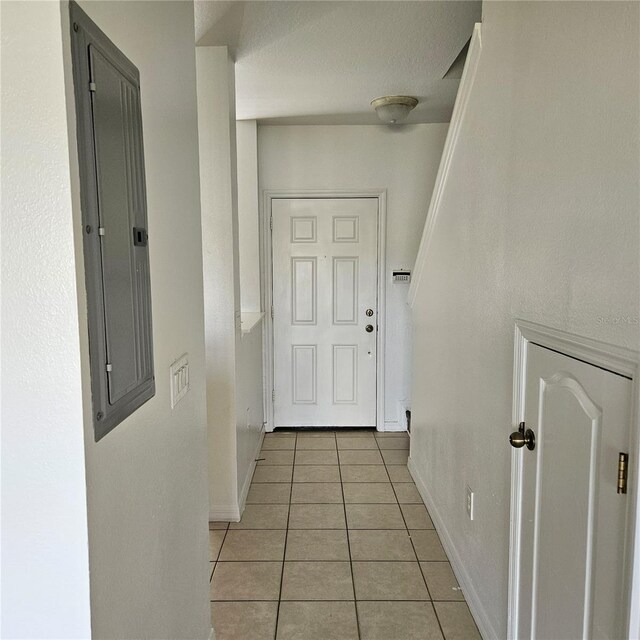 652 Chelsea Dr, Davenport, FL 33897 - corridor with light tile patterned flooring, baseboards, and electric panel