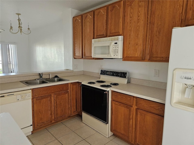 652 Chelsea Dr, Davenport, FL 33897 - kitchen featuring white appliances, a sink, brown cabinets, and plenty of natural light