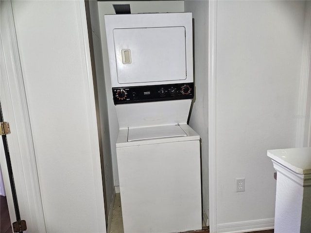 laundry room with stacked washer / drying machine