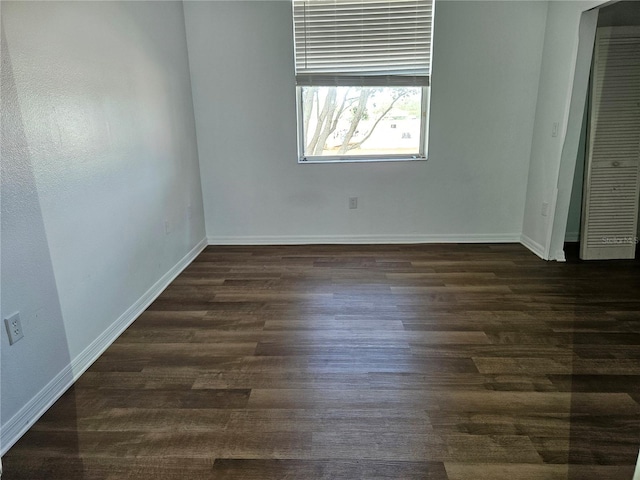 652 Chelsea Dr, Davenport, FL 33897 - unfurnished bedroom featuring dark wood-style floors and baseboards