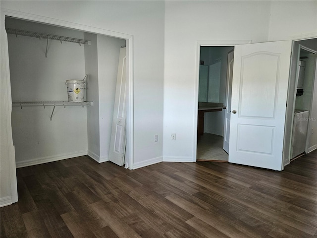 652 Chelsea Dr, Davenport, FL 33897 - unfurnished bedroom with dark wood-style flooring, baseboards, and connected bathroom