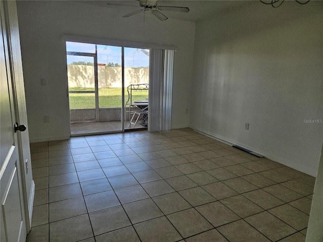 tiled spare room with ceiling fan