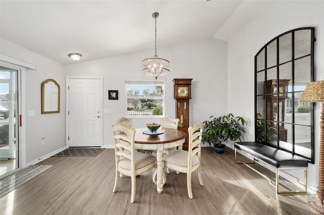 dining space with hardwood / wood-style flooring, plenty of natural light, and lofted ceiling