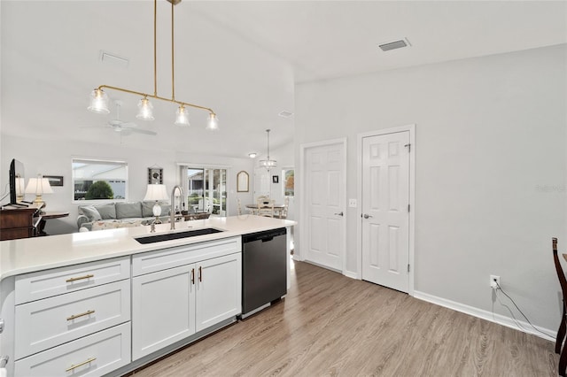 kitchen featuring dishwasher, sink, hanging light fixtures, light hardwood / wood-style floors, and white cabinetry