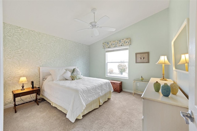 bedroom with ceiling fan, light colored carpet, and vaulted ceiling