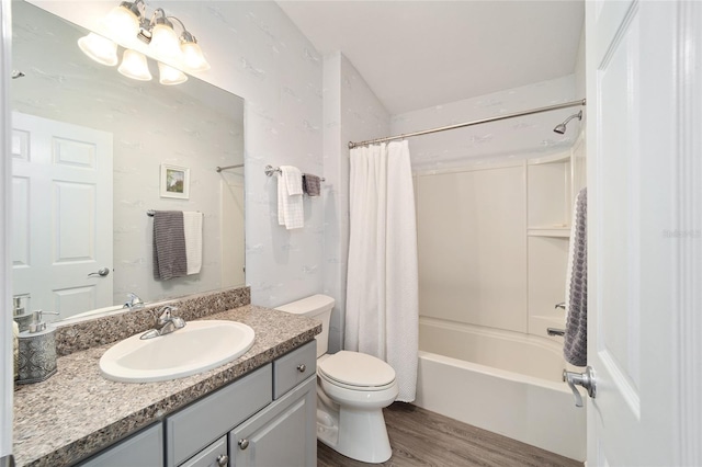 full bathroom featuring hardwood / wood-style floors, vanity, toilet, and shower / bath combo with shower curtain