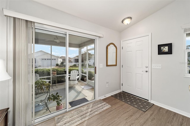 foyer entrance featuring hardwood / wood-style floors and vaulted ceiling