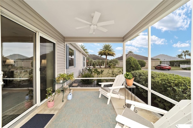 sunroom / solarium featuring ceiling fan