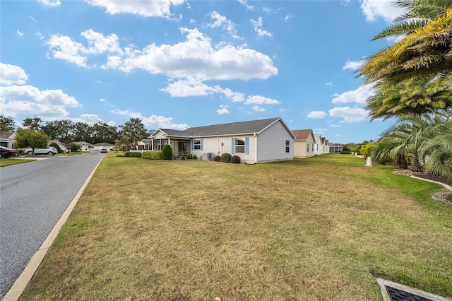 view of front of house with a front lawn and cooling unit