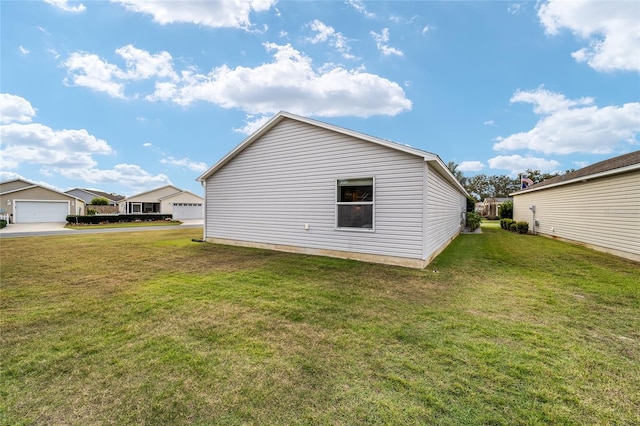 view of side of home with a lawn