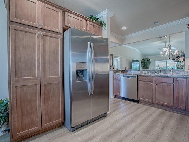 kitchen featuring lofted ceiling, crown molding, light hardwood / wood-style floors, and stainless steel appliances