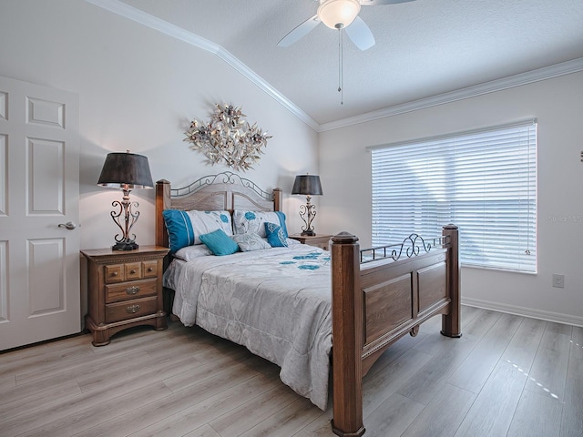 bedroom featuring light hardwood / wood-style floors, ceiling fan, vaulted ceiling, and ornamental molding