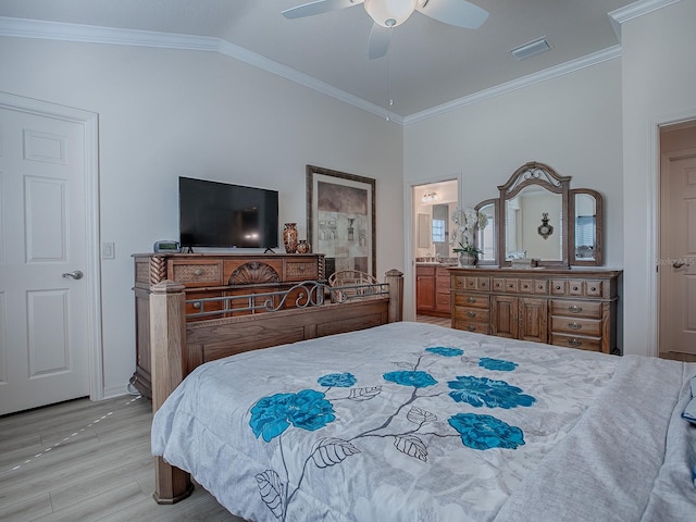 bedroom featuring ensuite bath, ornamental molding, ceiling fan, light hardwood / wood-style flooring, and lofted ceiling