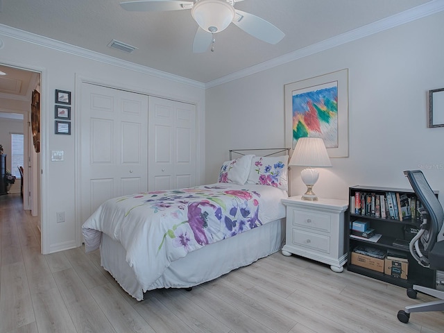 bedroom with light hardwood / wood-style flooring, ceiling fan, crown molding, and a closet