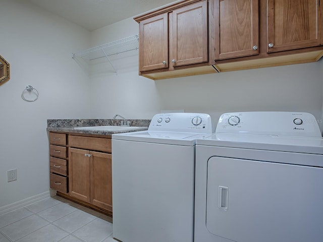 washroom featuring cabinets, light tile patterned flooring, sink, and independent washer and dryer