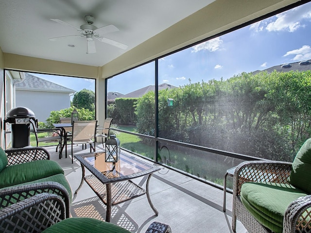 sunroom featuring a mountain view and ceiling fan