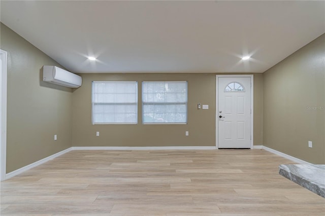 entrance foyer featuring light hardwood / wood-style flooring and a wall mounted AC