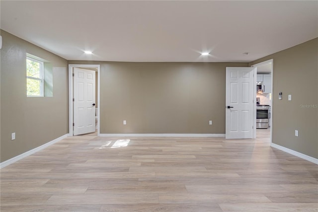 unfurnished room with light hardwood / wood-style flooring