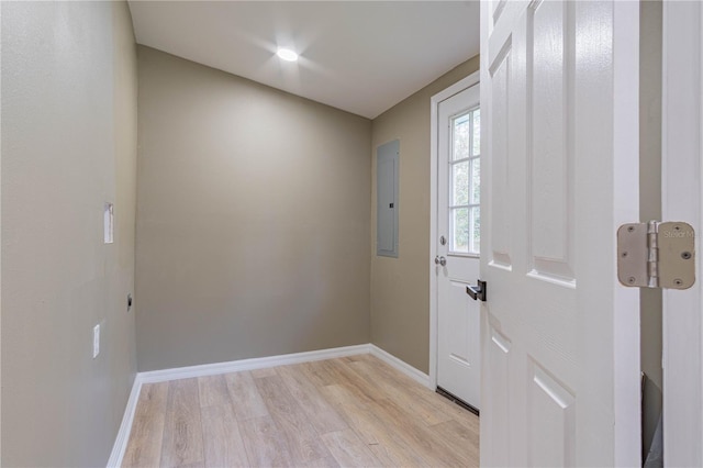 doorway with electric panel and light hardwood / wood-style flooring