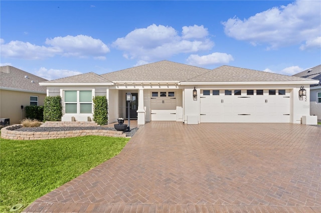 view of front of home with a front yard and a garage