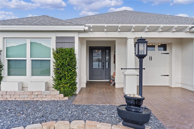 view of exterior entry with a garage