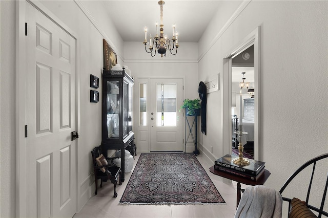 tiled entrance foyer featuring a chandelier