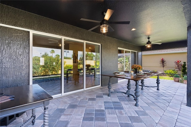 unfurnished office with a ceiling fan, recessed lighting, a textured wall, and a textured ceiling