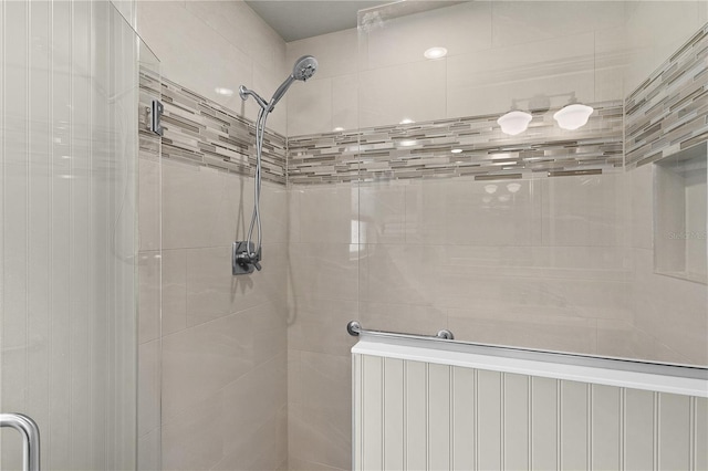 bathroom featuring a shower with shower door and radiator heating unit