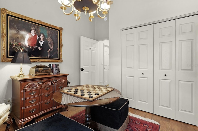 sitting room featuring light wood-type flooring and an inviting chandelier