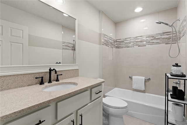 full bathroom with vanity, tiled shower / bath combo, and toilet