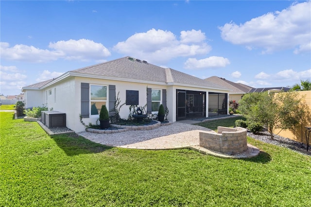 rear view of property with a sunroom and a yard