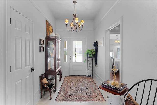 entryway featuring baseboards and a notable chandelier