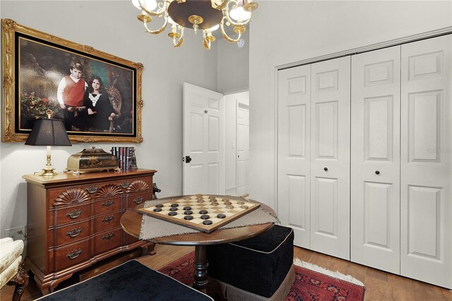 interior space featuring a closet, light wood-style flooring, and an inviting chandelier